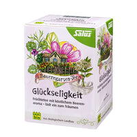 Hierba de Glückseligkeit Felicidad de SalusFlora en una botella con cápsulas, muestra el envase y las cápsulas blancas y verdes.